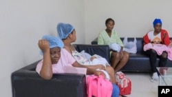 FILE - Women who recently gave birth wait for medical attention at the Nuestra Señora de la Altagracia Maternity Hospital in Santo Domingo, Dominican Republic, Dec. 10, 2023. 