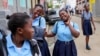 Students strike poses at the end of their school day, in Cap-Haitien, Haiti, April 17, 2024.