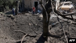 UKRAINE-RUSSIA-CONFLICT-WAR
27/140 characters
Local residents stand next to a crater and a destroyed residential house following a missile strike in Kyiv region, on Aug. 27, 2023, amid the Russian invasion of Ukraine. 