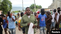 FILE - Gang leader and former police officer Jimmy "Barbecue" Cherizier leads a march against Haiti's Prime Minister Ariel Henry, in Port-au-Prince, Haiti, Sept. 19, 2023. 