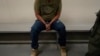 FILE - An immigrant considered a threat to public safety and national security waits to be processed by U.S. Immigration and Customs Enforcement agents at the ICE Metropolitan Detention Center in Los Angeles, after an early morning raid, June 6, 2022.