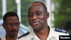 U.S. Assistant Secretary of State for International Narcotics and Law Enforcement Affairs (INL) William Brownfield (2nd L) speaks with Mario Andresol, director general of the Haitian Police Force, as he arrives for a news conference at the Haitian Police 