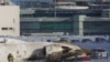 An emergency responder works around an aircraft on a runway after a plane crash at Toronto Pearson International Airport in Mississauga, Ontario, Canada, Feb. 17, 2025.