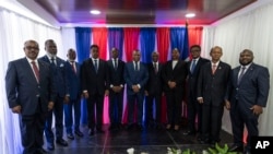 FILE - Members of the Haiti Transitional Council pose for a group photo during an installation ceremony, in Port-au-Prince, Haiti, April 25, 2024.