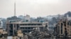 Tents are erected outside the rubble of a collapsed building by the destroyed Sheikh Radwan Health Centre, run by the United Nations Relief and Works Agency for Palestine Refugees (UNRWA), in the north of Gaza City on February 10, 2025 amid the current ce