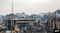 Tents are erected outside the rubble of a collapsed building by the destroyed Sheikh Radwan Health Centre, run by the United Nations Relief and Works Agency for Palestine Refugees (UNRWA), in the north of Gaza City on February 10, 2025 amid the current ce