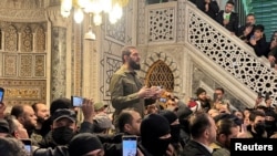 FILE PHOTO: Top rebel commander Abu Mohammed al-Golani speaks to a crowd at Ummayad Mosque in Damascus