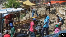 Residents of the Nazon neighborhood displaced by gang violence construct a tent encampment in Port-au-Prince, Haiti, Nov. 15, 2024.