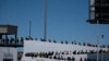 Asylum seekers walk for their asylum interview appointment with US authorities at the El Chaparral crossing port in Tijuana, Baja California State, Mexico, on May 18, 2024.