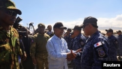 Leslie Voltaire, president of Haiti's transition council, welcomes a military contingent from El Salvador, at the Toussaint Louverture International Airport, in Port-au-Prince, Haiti, Feb. 4, 2025. 