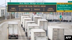 A line of trucks wait to cross the Bluewater Bridge border crossing between Sarnia, Ontario and Port Huron, Michigan on January 29, 2025.