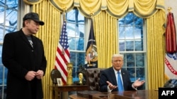 Elon Musk listens as US President Donald Trump speaks in the Oval Office of the White House in Washington, DC, on February 11, 2025.