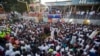 Families and friends gather around a memorial at the site of a high-voltage wire accident that left at least 16 people dead, during a vigil in Port-au-Prince, Haiti, Feb. 17, 2015. 