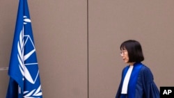 FILE - Judge Tomoko Akane walks before delivering a verdict at the International Criminal Court in The Hague, Netherlands, Nov. 20, 2024.