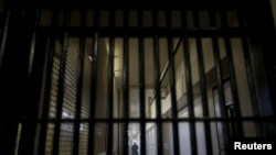 A guard stands behind bars at the Adjustment Center during a media tour of California's Death Row at San Quentin State Prison in San Quentin, California December 29, 2015. America's most populous state, which has not carried out an execution in a decade, 