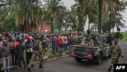 Members of the M23 armed group arrive in a pickup truck at the compound where residents gather for a protest against the Congolese government, expressing support for the M23 armed group in Goma on January 31, 2025.