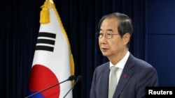 Acting South Korean President and Prime Minister Han Duck-soo delivers an address to the nation at the government complex in Seoul