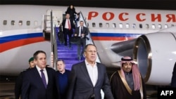 TOPSHOT - This handout picture taken and released by the Russian Foreign Ministry on their "X" social media account shows Russian Foreign Minister Sergei Lavrov (C) arriving in Saudi Arabia prior to a meeting with US Secretary of State in Riyad on Februar