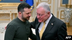 Ukraine's President Volodymyr Zelensky (L) greets US envoy Keith Kellogg at his offices in Kyiv on February 20, 2025, amid the Russian invasion of Ukraine.