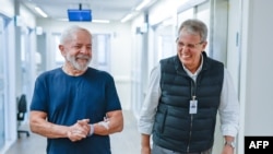 This handout picture released by the Brazilian Vice Presidency shows President Luiz Inacio Lula da Silva (L) walking with his neurosurgeon Dr Marcos Stavale in the Syrian-Lebanese Hospital in Sao Paulo, Brazil, on December 13, 2024.