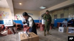 A voter casts her ballot during the presidential election in Quito, Ecuador, Feb. 9, 2025.