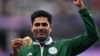 Gold medallist Pakistan's Arshad Nadeem celebrates on the podium during the victory ceremony for the men's javelin throw athletics event during the Paris 2024 Olympic Games at Stade de France in Saint-Denis, north of Paris, on August 9, 2024. (Photo by Ki